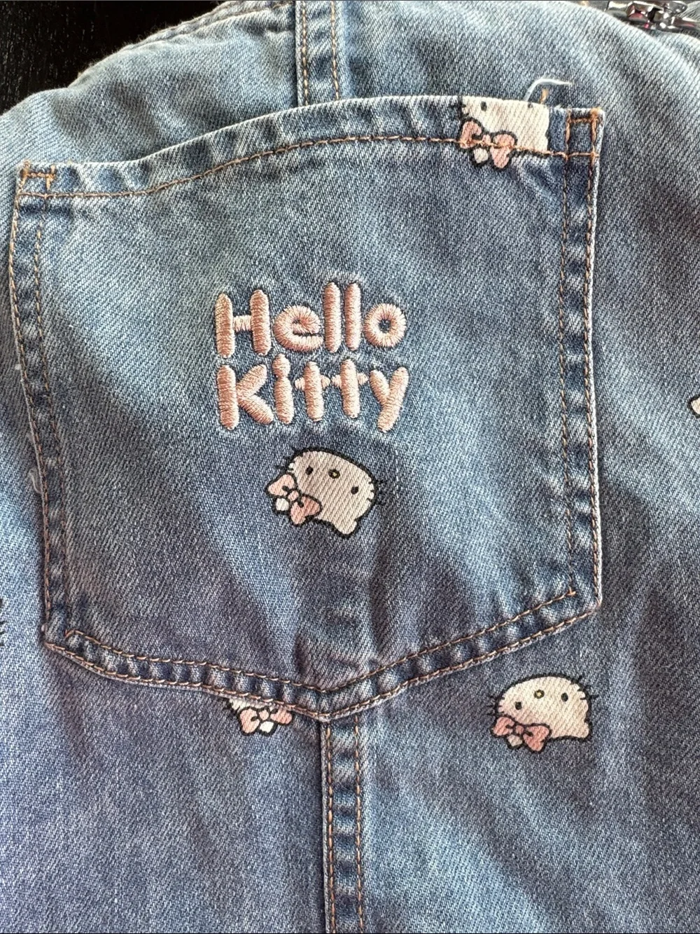 Hello Kitty Light Blue Denim Overall Dress with All-Over Kitty Faces - Picture 3 of 4